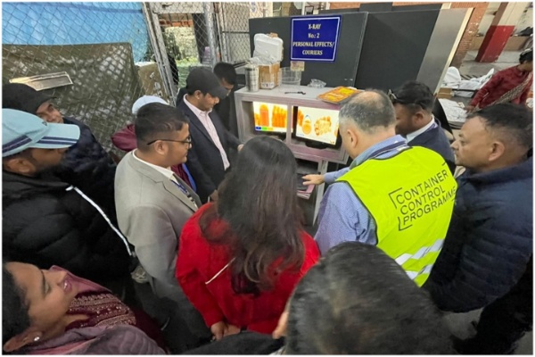 Participants standing around an X-Ray Machine while working on a group exercise.