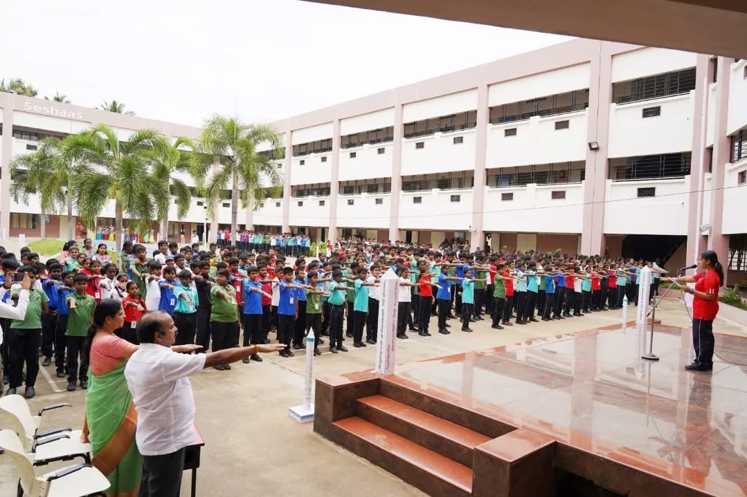 Students and teachers taking a pledge for peace at a morning assembly in a school