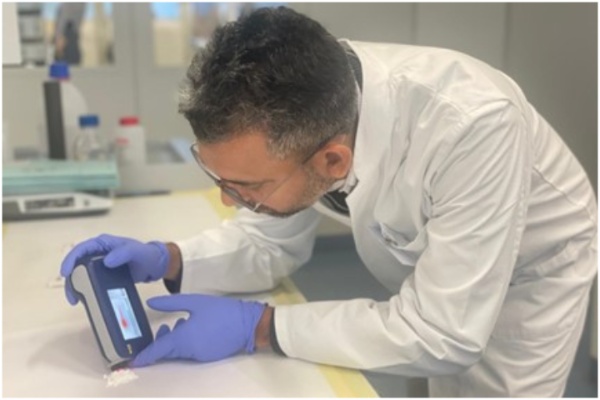 A participating official using an instrument at the lab. A participating official using an instrument at the lab.