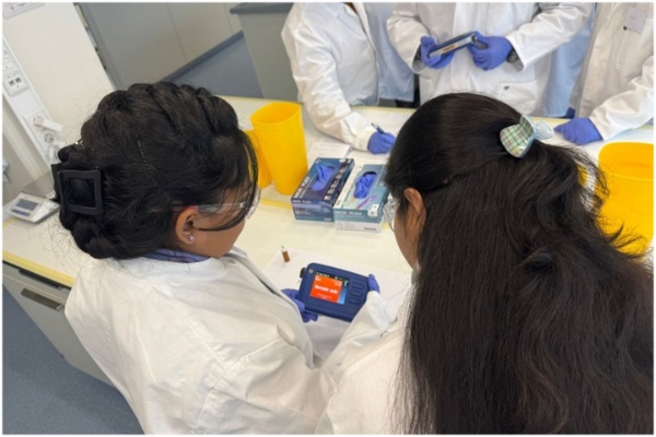 Two participating officials looking at a scanner and conducting an exercise. Two participating officials looking at a scanner and conducting an exercise.