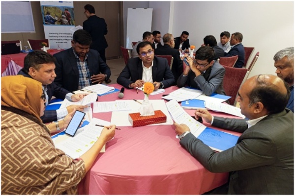Participants seated around a table, engaging in open discussions.