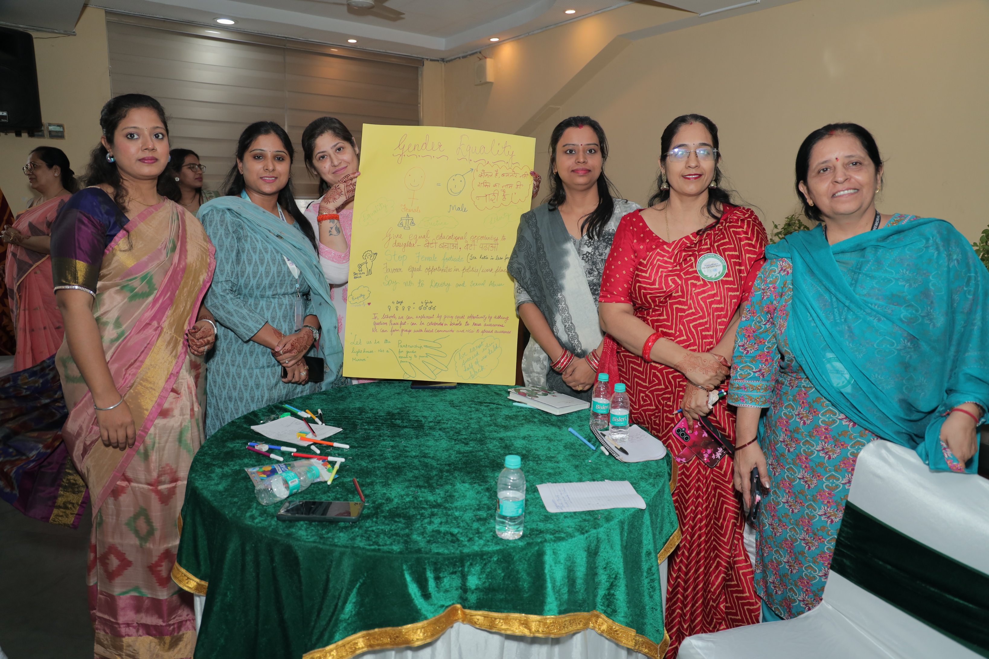 Educators holding up a chart depicting key takeaways from their discussions during a workshop.
