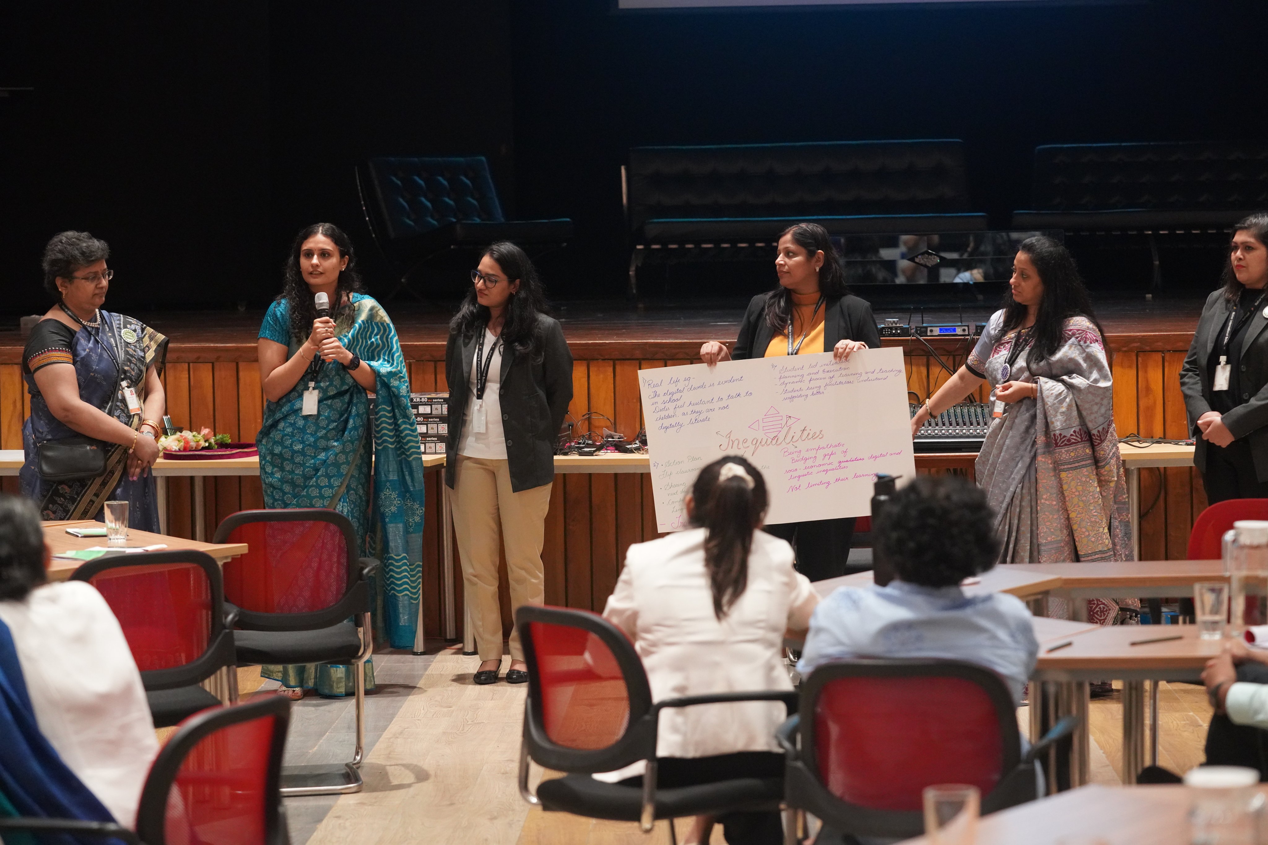 Educators discussing among themselves during a workshop.